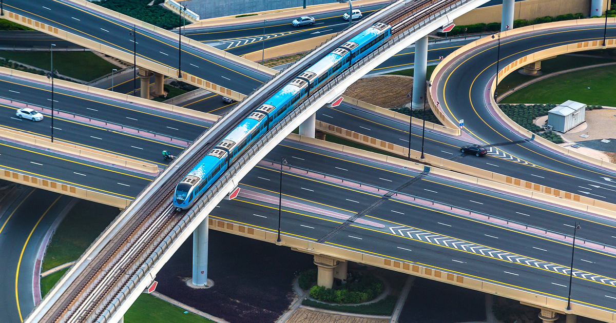 A train travelling over a junction of highways A train travelling over a junction of highways